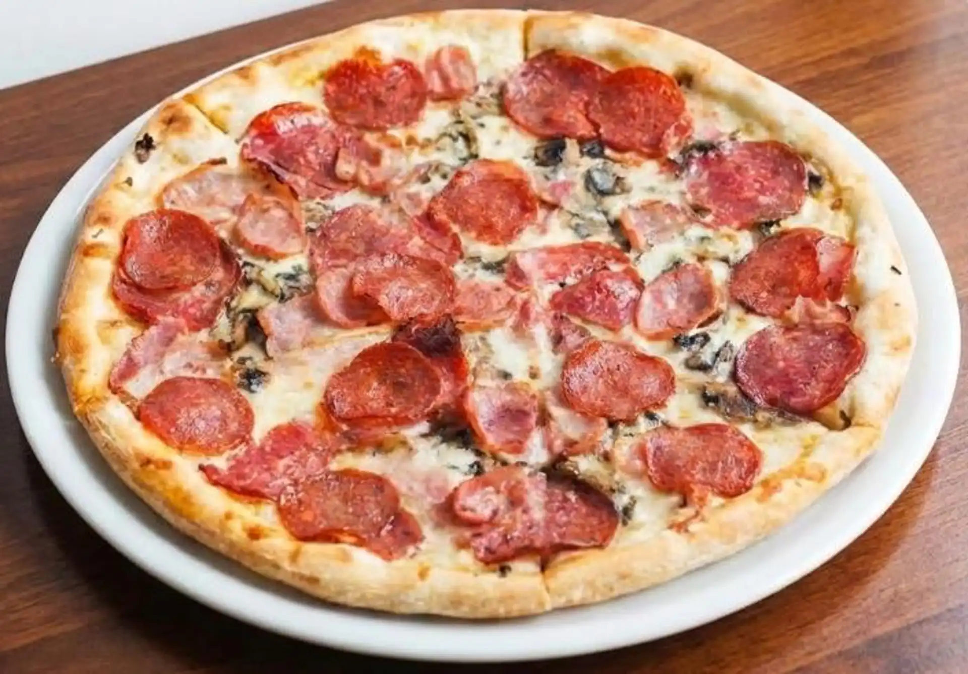 Chicago deep dish pizza with thick buttery crust at Calgary's Original